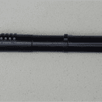 A black pen with a number of holes on it.