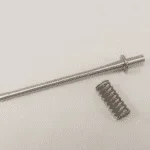 A metal rod and springs are sitting on the table.