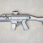 A gun that is sitting on the ground.