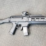 A gun that is laying on the ground.