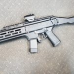 A gun that is laying on the ground.