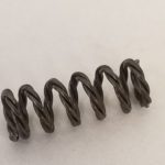 A close up of the springs on a white surface