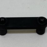A black plastic handle with two small holes.