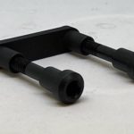 A black handle is sitting on top of the floor.