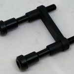 A black piece of metal with two bolts attached to it.