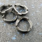 A group of four metal rings on top of a floor.