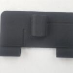 A black plastic cover that is sitting on the floor.