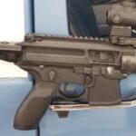 A close up of an ar-1 5 rifle with the magazine open.