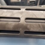A close up of the front end of a rifle