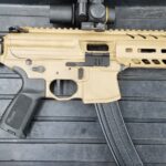 A rifle with an ar-1 5 style magazine and a scope.
