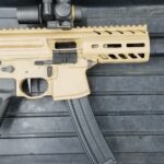 A rifle with a sight and a rail on it