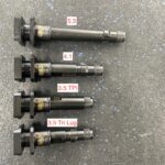 A set of four different types of ignition coils.