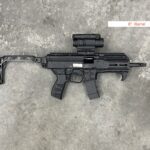 A black gun with a sight and a handle on it.