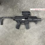 A black gun with a red dot sight on it.