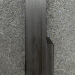 A black metal pole on the side of a wall.
