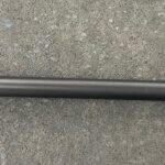 A close up of the end of a rifle barrel
