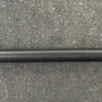 A close up of the end of a long metal pole.