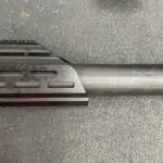 A close up of the bottom end of a rifle
