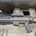 A gun that is sitting in the floor.