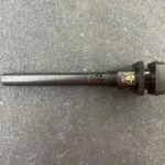 A black pipe sitting on top of a floor.