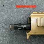 A rifle that is laying on the ground.