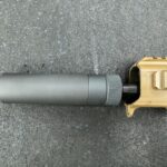 A gun that is laying on the ground.