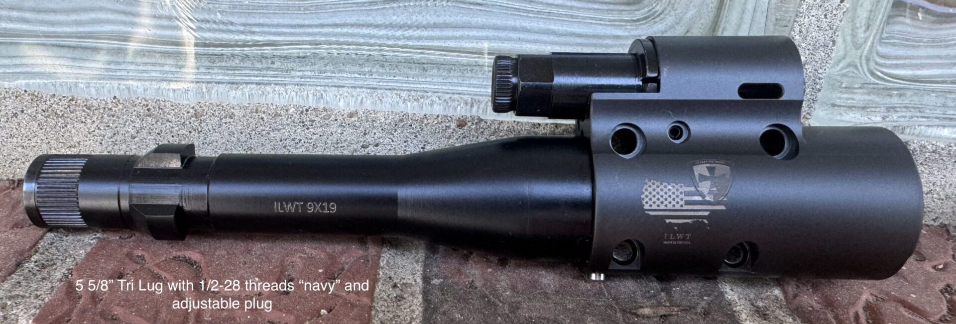 A close up of the barrel and scope on a rifle