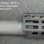 A close up of the barrel and handguard on a rifle
