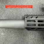 A rifle with an extended barrel and the sight on it.